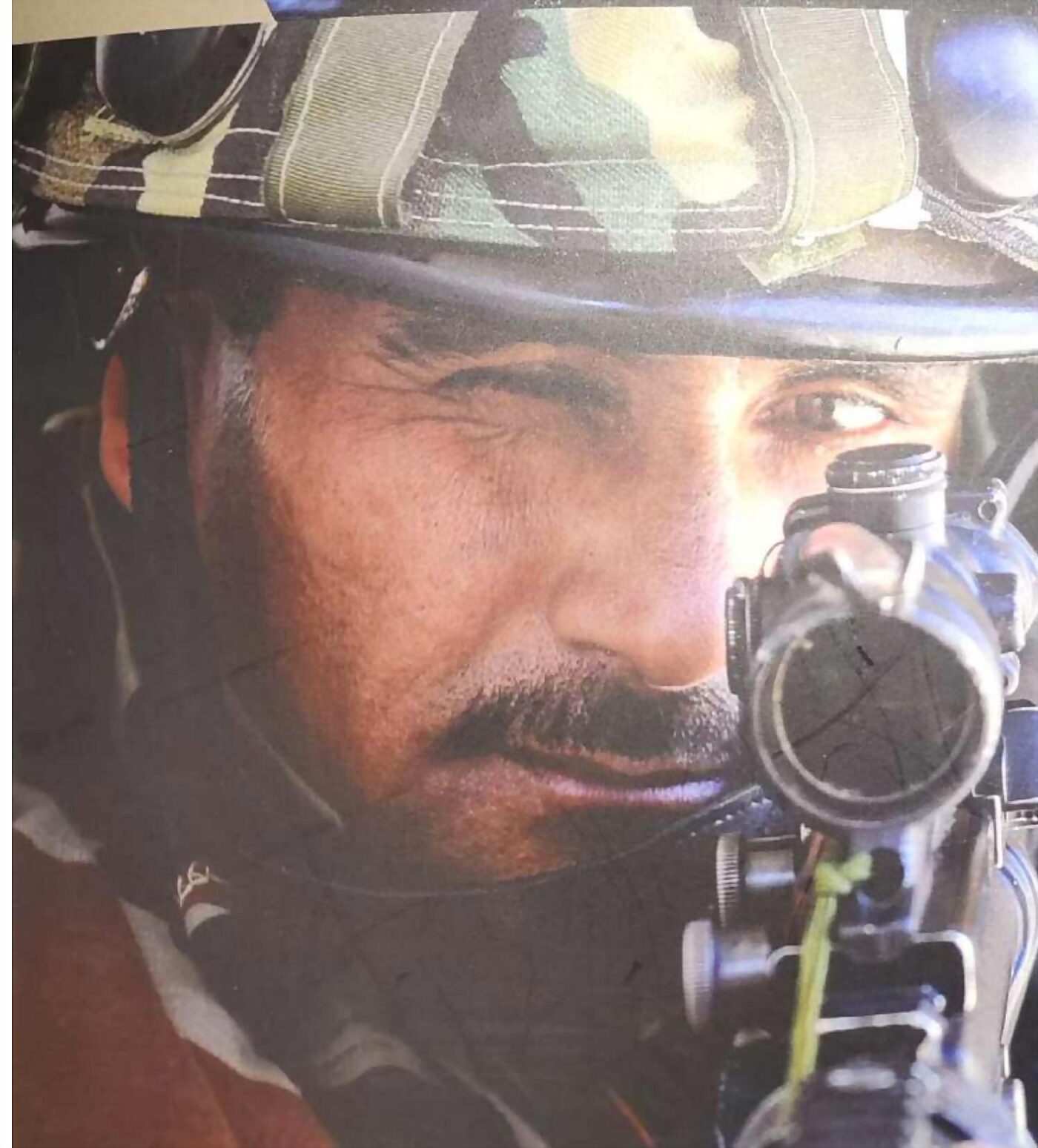 An Indian Army soldier sighting down a rifle optic