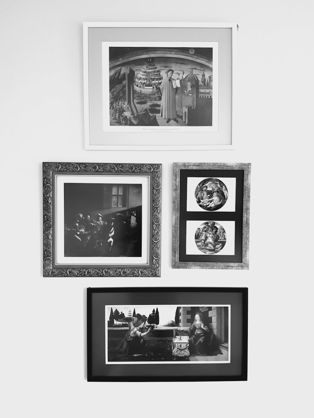 Five framed black and white photographs arranged on a pale wall