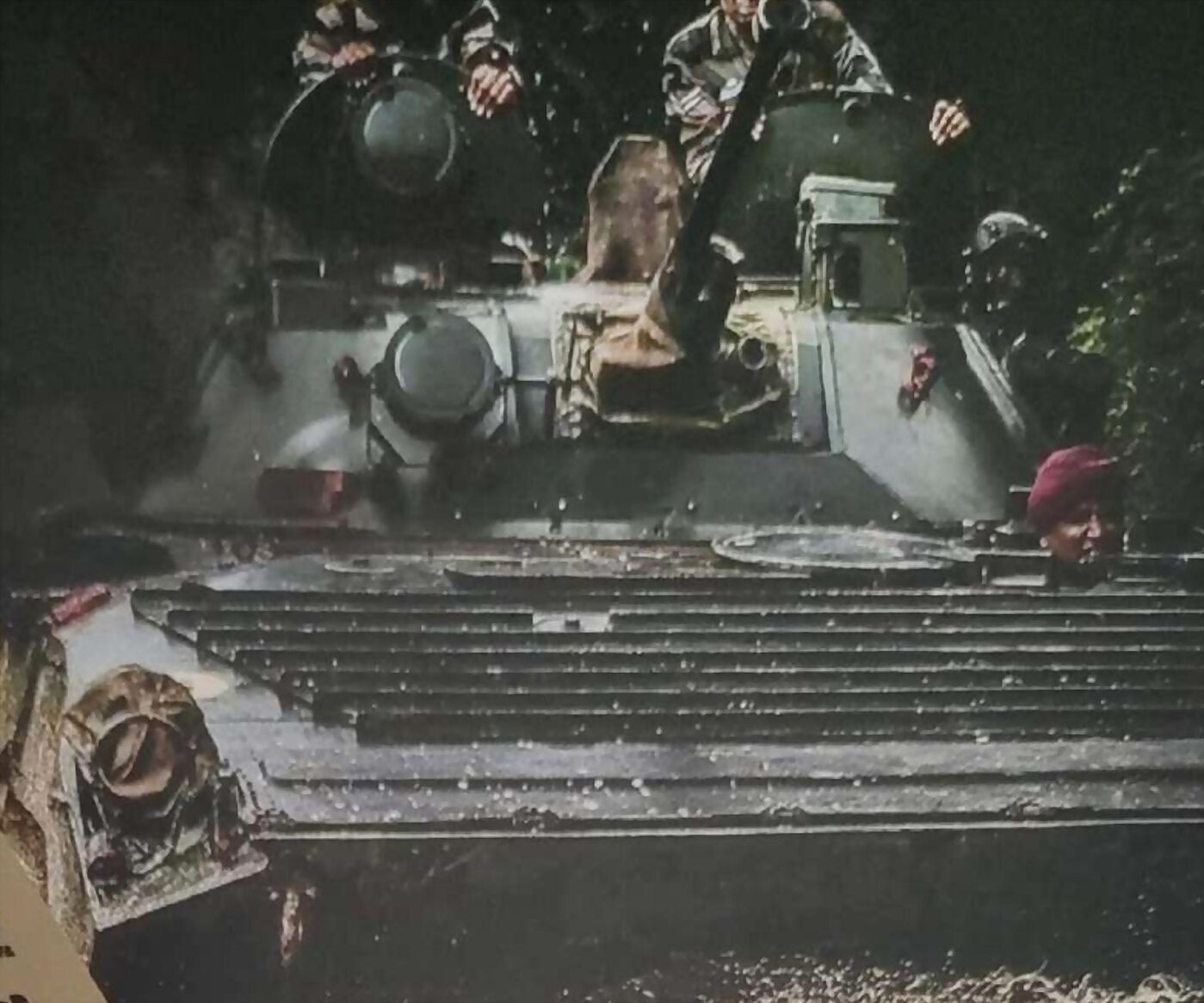 An armoured personnel carrier fording water with its crew up